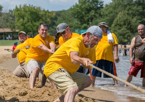 Brad and the yellow team playing tug of war at the company picnic