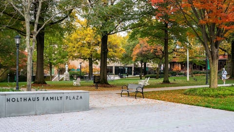 sign at loyola university and landscape in fall