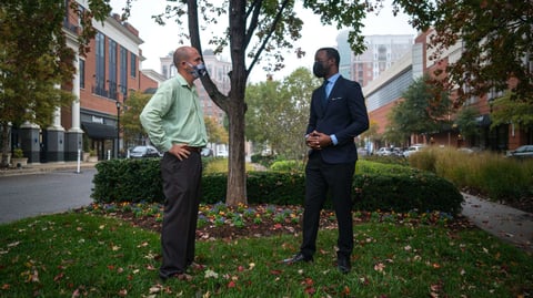 property manager and landscaper meet on lawn