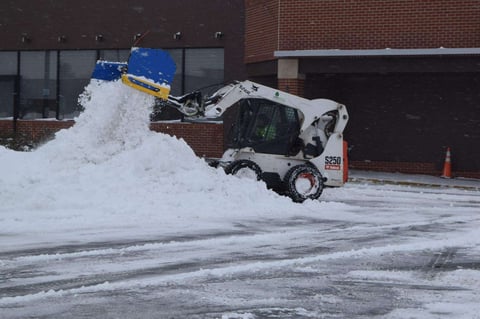 skid loader piles snow