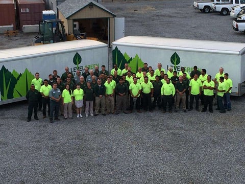 level green team in front of trailers