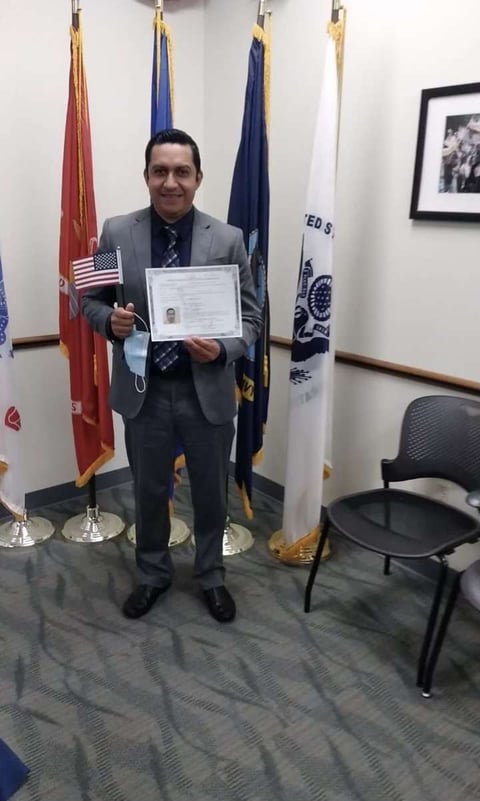 Rosin holding american flag and citizenship certificate