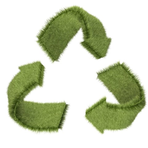 Recycling symbol in grass texture