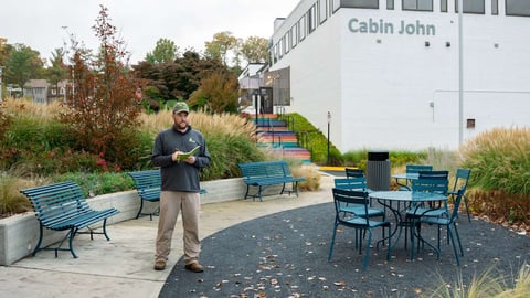 Commercial landscaping technician inspecting property