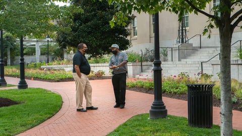 Commercial property manager speaking with landscaper